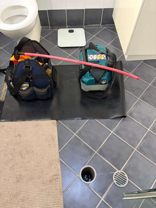 Floor protected with a mat while clearing a bathroom drain in Maroubra